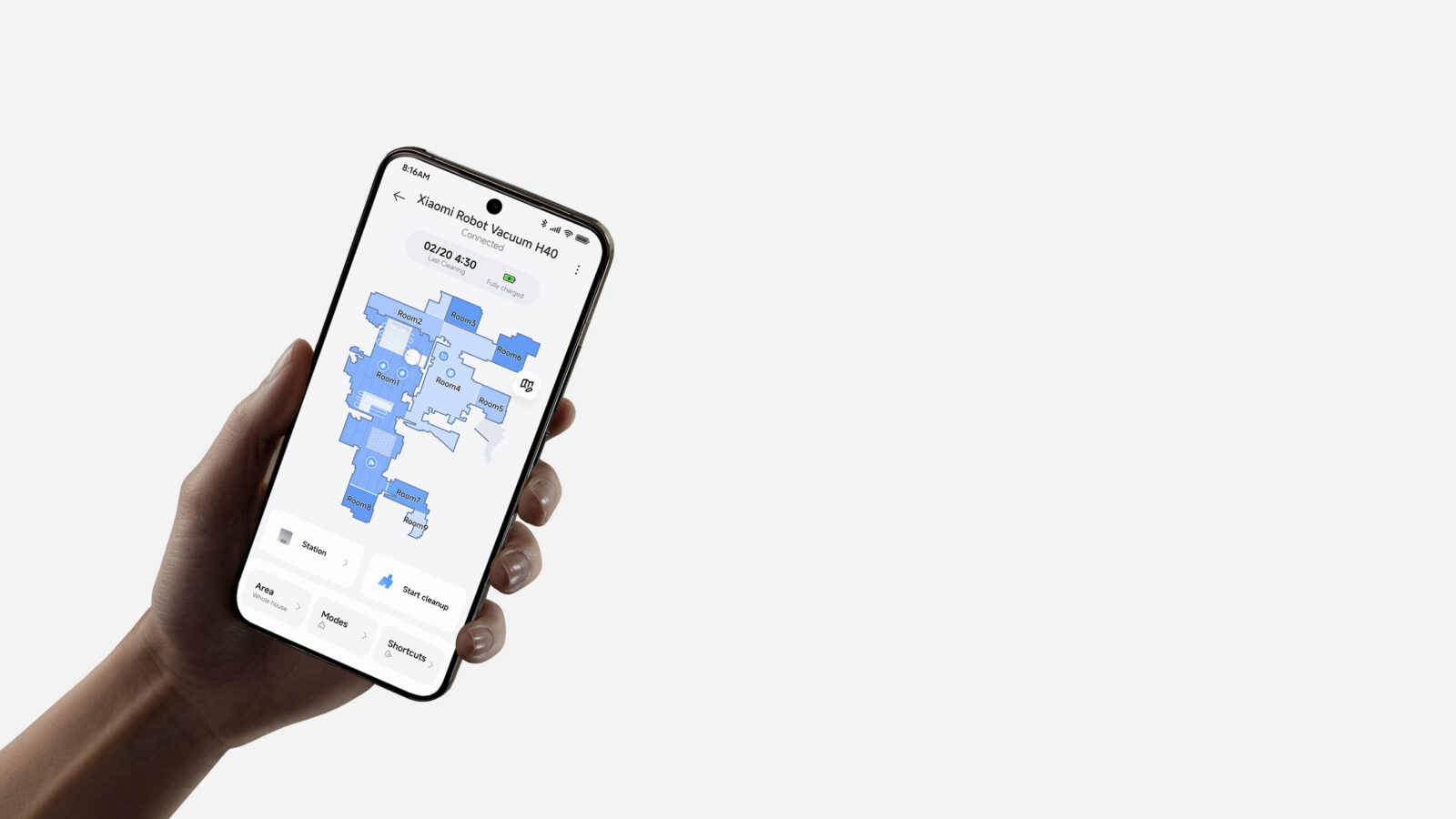 Mão segurando celular com o app Xiaomi Home mostrando o mapa dos cômodos do Xiaomi Robot Vacuum H40