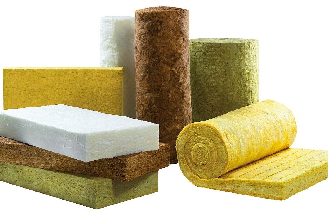 Placas, rolos e mantas de lã mineral de diferentes tipos e densidades empilhados sobre fundo branco